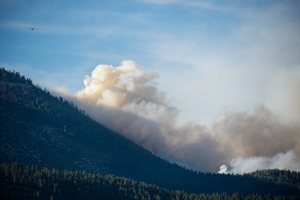 Planes flying and dropping water on the Davis Fire
